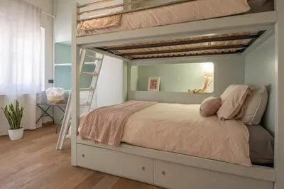 a bedroom with a bunk bed with a ladder at Suite Color Family Roma in Rome