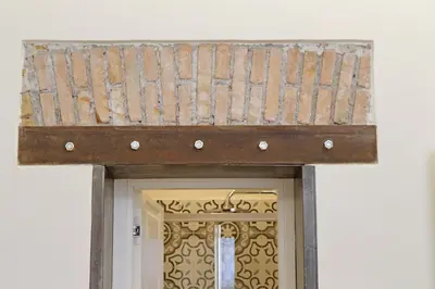 a wooden roof over the door of a building at Cozy new flat near the Station! in Rome