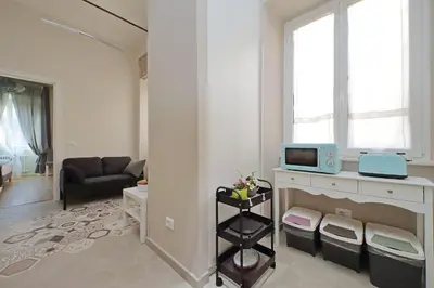 a living room with a couch and a microwave at Cozy new flat near the Station! in Rome