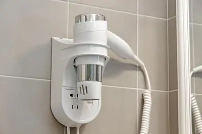 a shower head on a wall in a bathroom at Cozy new flat near the Station! in Rome