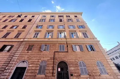 a tall brick building with many windows on it at Cozy new flat near the Station! in Rome