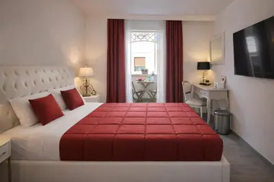 a bedroom with a large bed with a red blanket at RomAntic Dreams Guest House in Rome