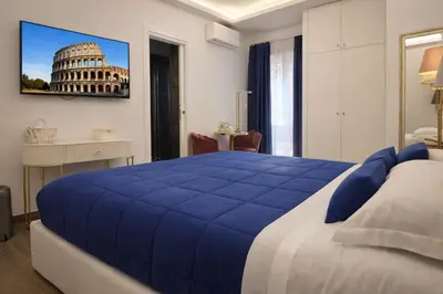a bedroom with a large blue bed in a room at RomAntic Dreams Guest House in Rome