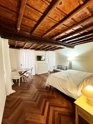 a bedroom with a bed and a table at Navona Fox House 1 in Rome