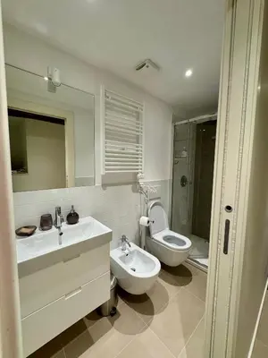a bathroom with two sinks and a toilet and a tub at Navona Fox House 1 in Rome