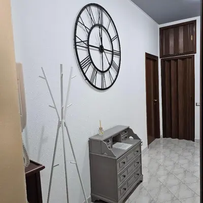 a room with a clock on the wall and a dresser at Casa Nostra a Centocelle in Rome