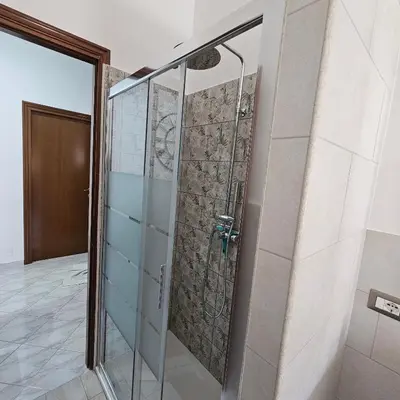 a shower in a bathroom with a glass door at Casa Nostra a Centocelle in Rome