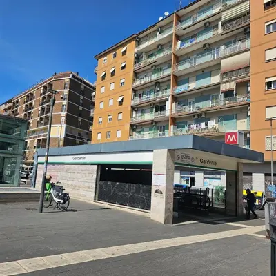 a building with a parking garage in front of it at Casa Nostra a Centocelle in Rome