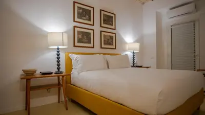 a bedroom with a white bed and two lamps at Domus Oro nel cuore di Roma in Rome