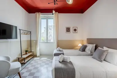 a hotel room with two beds and a tv at Flowers Apartment - grande casa a Montesacro in Rome