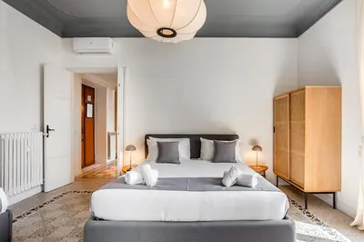 a bedroom with a large bed and a ceiling at Flowers Apartment - grande casa a Montesacro in Rome