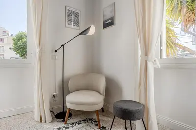 a chair and a lamp in a room with a window at Flowers Apartment - grande casa a Montesacro in Rome