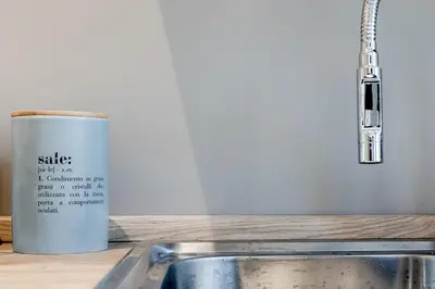a cup sitting on a counter next to a sink at Flowers Apartment - grande casa a Montesacro in Rome
