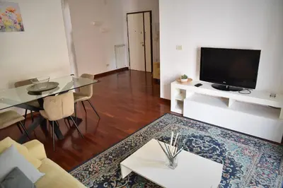 a living room with a glass table and a television at L'Oasi di Ale in Rome