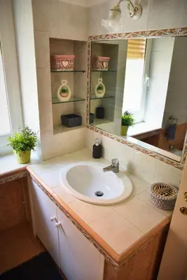 a bathroom with a sink and a mirror at L'Oasi di Ale in Rome