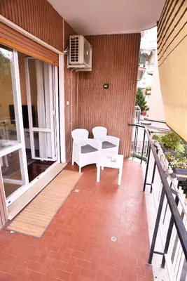 a balcony with two chairs and a table on a building at L'Oasi di Ale in Rome