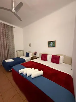 a hotel room with two beds and a flat screen tv at Niam House Volturno in Rome