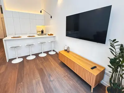 a living room with a large flat screen tv on a wall at Carlo Alberto Suite in Rome