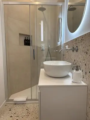 a bathroom with a sink and a shower at Carlo Alberto Suite in Rome