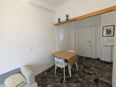 a living room with a table and a couch at Isolina 63 in Rome