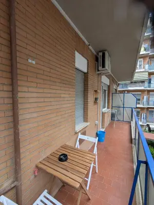 a patio with a wooden table and chairs on a building at Isolina 63 in Rome