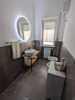 a bathroom with a sink and a mirror and a toilet at Isolina 63 in Rome
