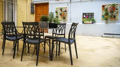 a table and chairs with plants on a patio at Domus Pietra nel cuore di Roma in Rome