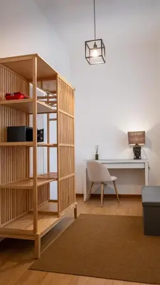 a room with a book shelf and a desk at Domus Pietra nel cuore di Roma in Rome