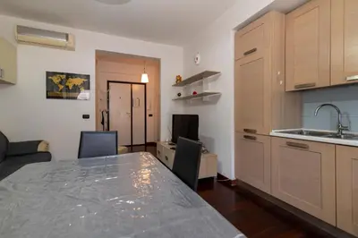 a hallway with white walls and a large light fixture at Apartment Marconi 2833 in Rome