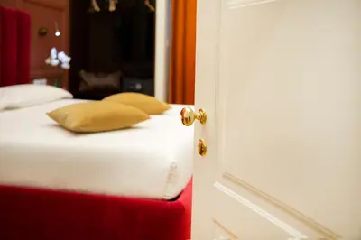 a close up of a bed with yellow pillows on it at Unicum Trastevere Suites in Rome