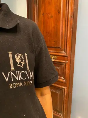 a person wearing a black shirt next to a door at Unicum Trastevere Suites in Rome