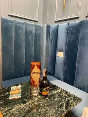 a bottle of alcohol and a glass on a table at Unicum Trastevere Suites in Rome