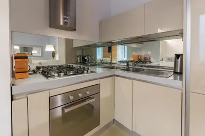 a kitchen with white cabinets and a stove at Gold Spanish's Steps in Rome