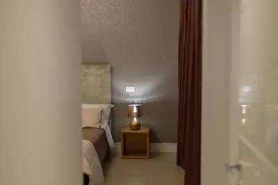 a bedroom with a bed and a lamp on a table at Gold Spanish's Steps in Rome