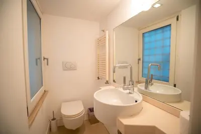 a white bathroom with a sink and a toilet at Gold Spanish's Steps in Rome