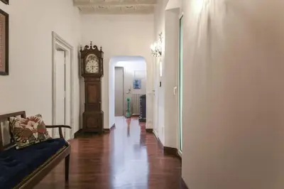 a hallway with a grandfather clock in a room at Donna Maria Apartment in Rome