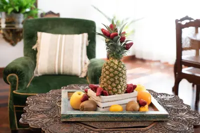 a pineapple sitting on a tray on a table with fruit at Donna Maria Apartment in Rome