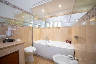 a bathroom with a tub and a toilet and a sink at Donna Maria Apartment in Rome