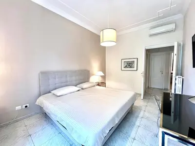 a bedroom with a bed and a flat screen tv at My Roman Home - Prati Vaticano in Rome
