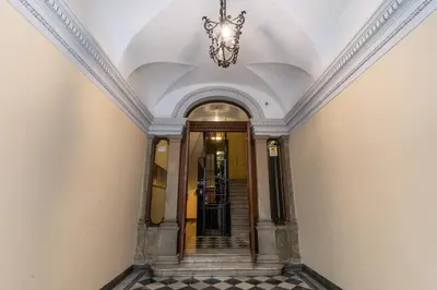 a hallway with a chandelier in a building at Corso charming suite in Rome