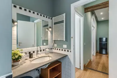 a bathroom with a sink and a mirror at Corso charming suite in Rome