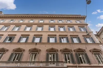 a large building with windows and a balcony at Corso charming suite in Rome