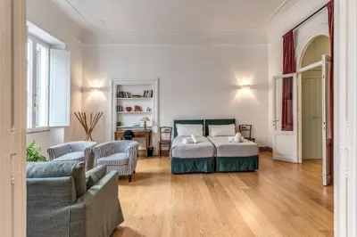 a bedroom with a bed and a living room at Corso charming suite in Rome