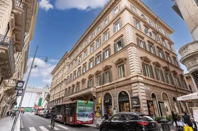 a large building on a city street with a bus at Corso charming suite in Rome