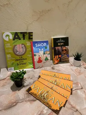 four books sitting on a table next to a wall at B&B La Perla di Roma in Rome