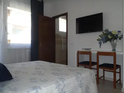 a bedroom with a bed and two chairs and a table at B&B La Perla di Roma in Rome