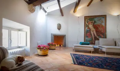 a living room with a dog laying on a couch at Ghetto Luxury Design Apartment in Rome