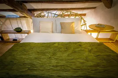 a bedroom with a large bed with a green blanket at Ghetto Luxury Design Apartment in Rome