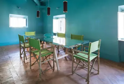a dining room with a glass table and green chairs at Ghetto Luxury Design Apartment in Rome