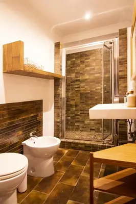a bathroom with a toilet and a sink and a shower at Saint John House in Rome